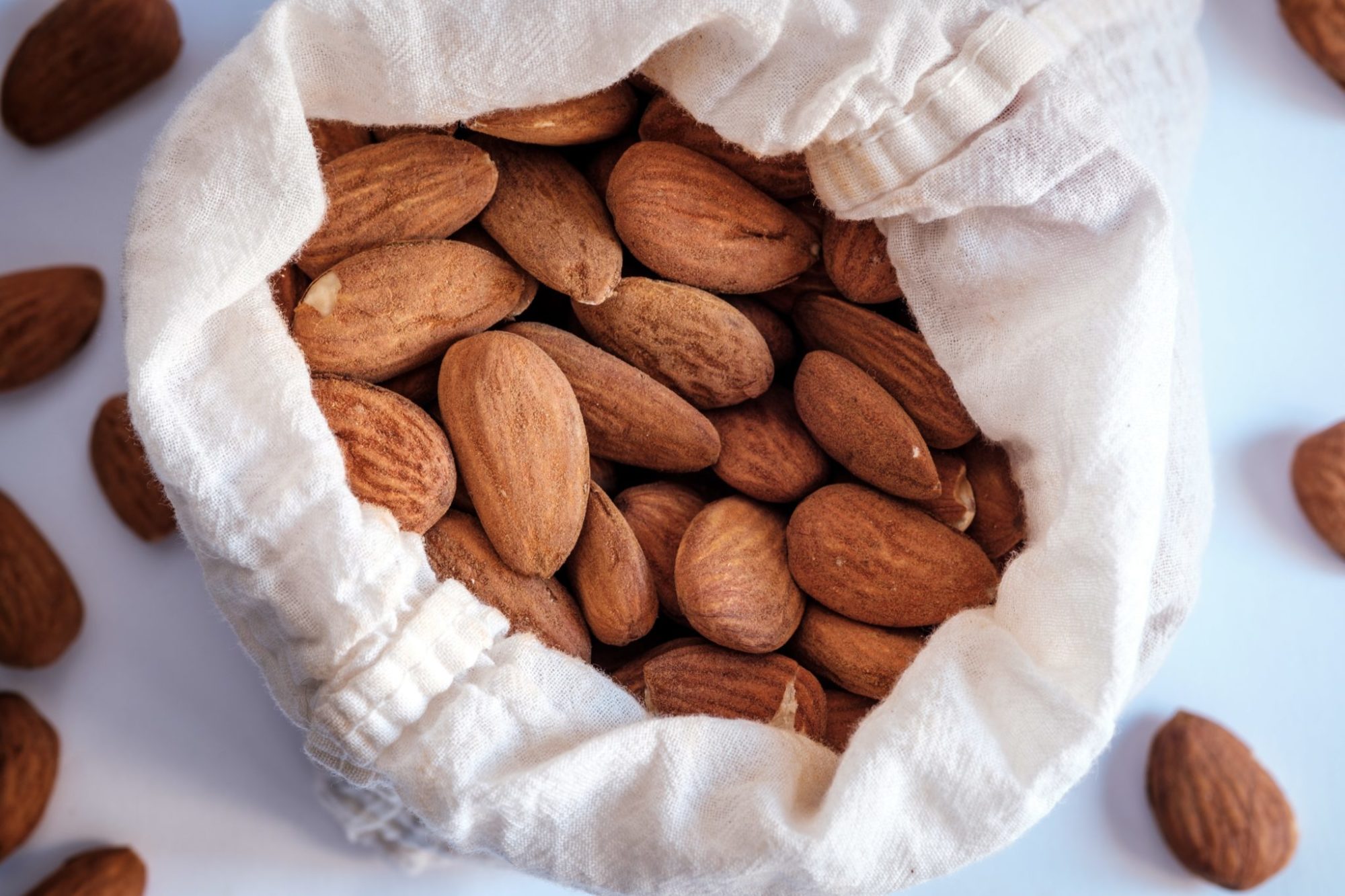 Raw almonds in a white bag